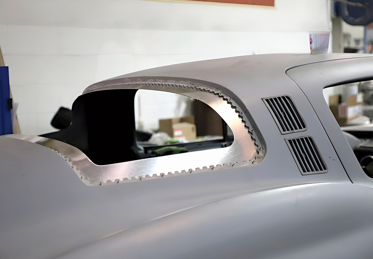 Close-up of a car's rear roofline showing a custom-cut window opening.