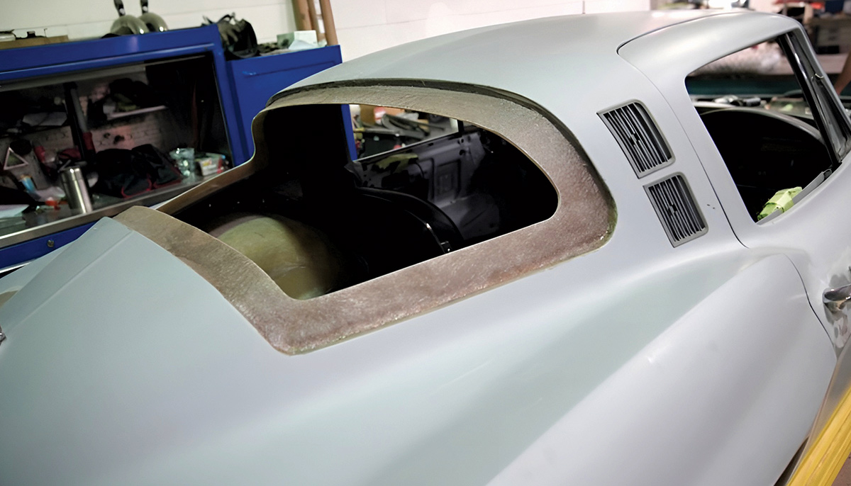 Newly molded fiberglass lip around the rear window opening of a car body.