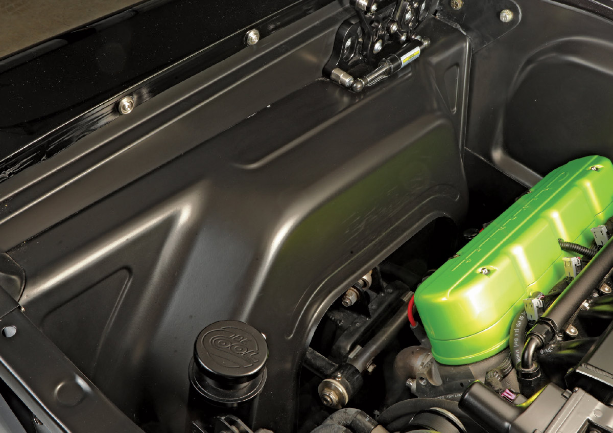 Engine bay view of a lime-green-accented modern LS engine.