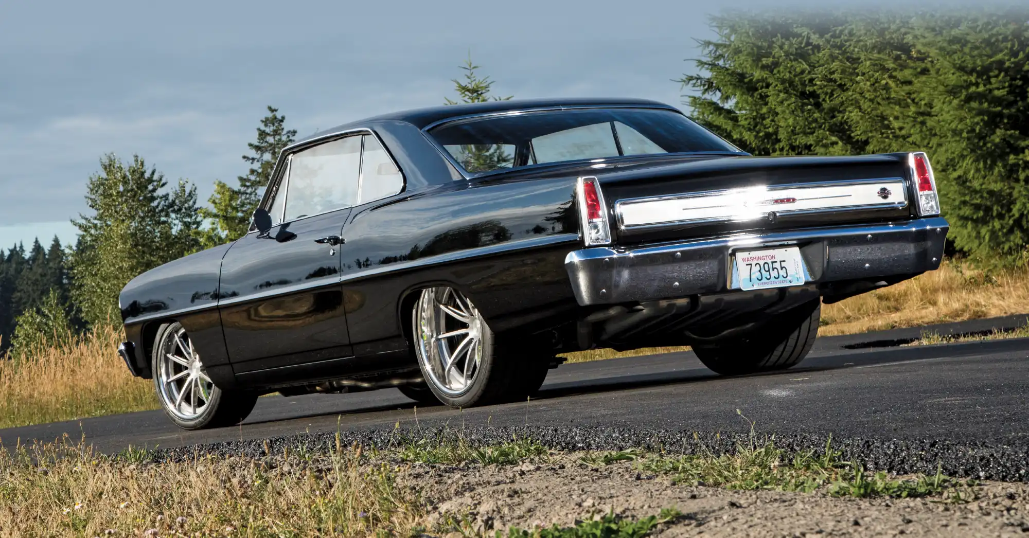 Rear three-quarter view of a black Nova.