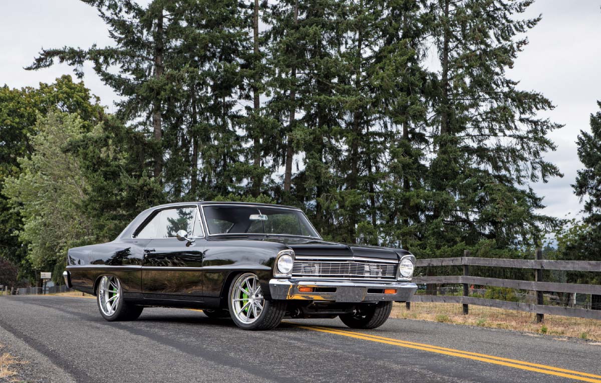 Front three-quarter shot of a black Nova parked on a road.