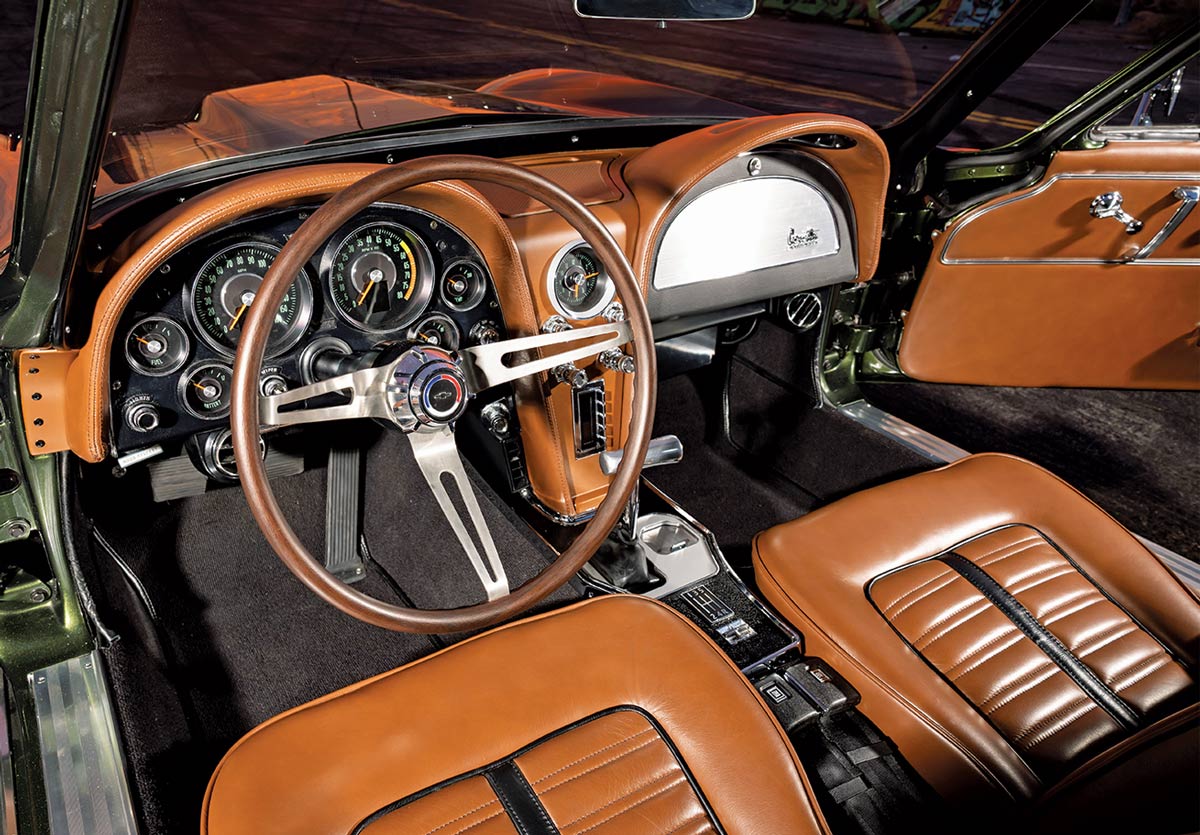 Interior view of the car featuring tan leather seats, a wood-rimmed steering wheel, and classic gauges.