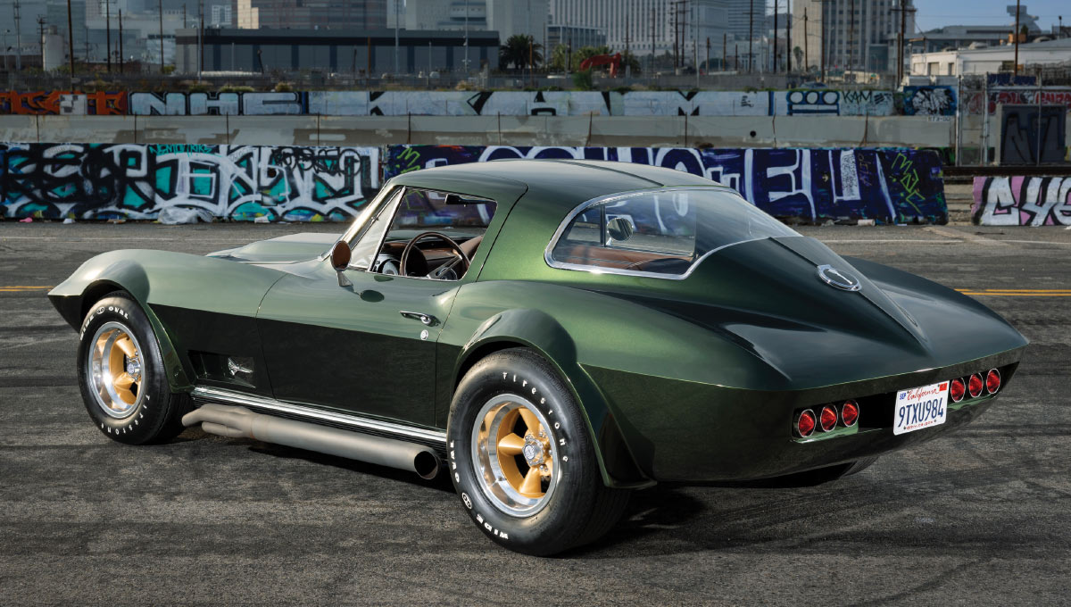 Rear view of the green Corvette parked in front of a city skyline.
