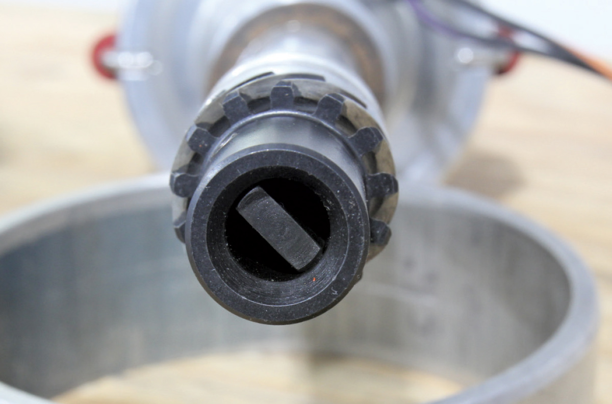Macro view of the distributor drive gear and the oil pump drive tang at the bottom of the shaft.