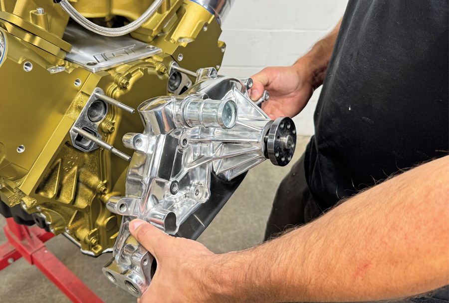 Sliding new water pump onto mounting studs