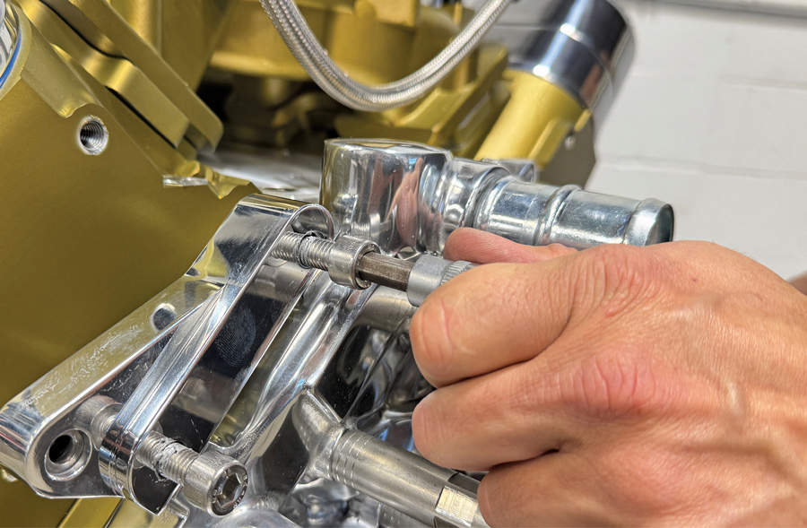 Attaching rear A/C compressor bracket to the block