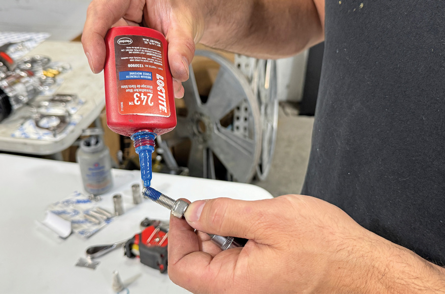 Applying blue Loctite to water pump pulley capscrews
