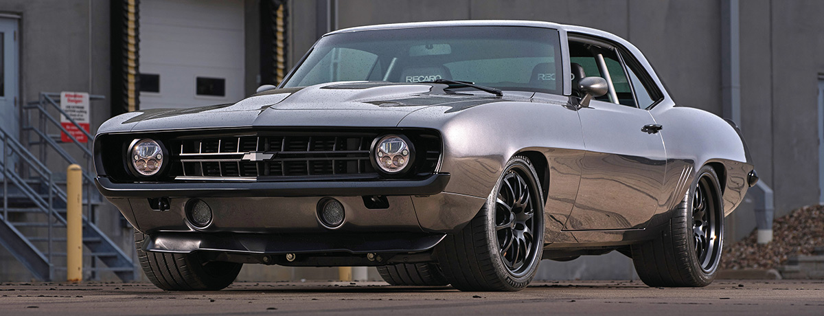Side view of the Camaro near an industrial building.