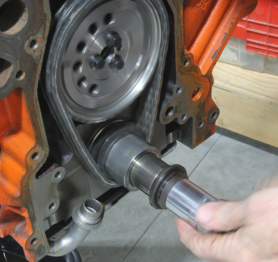 Camshaft being removed while rods retain the lifters.