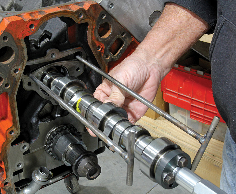 Sliding camshaft out using specialty tool.