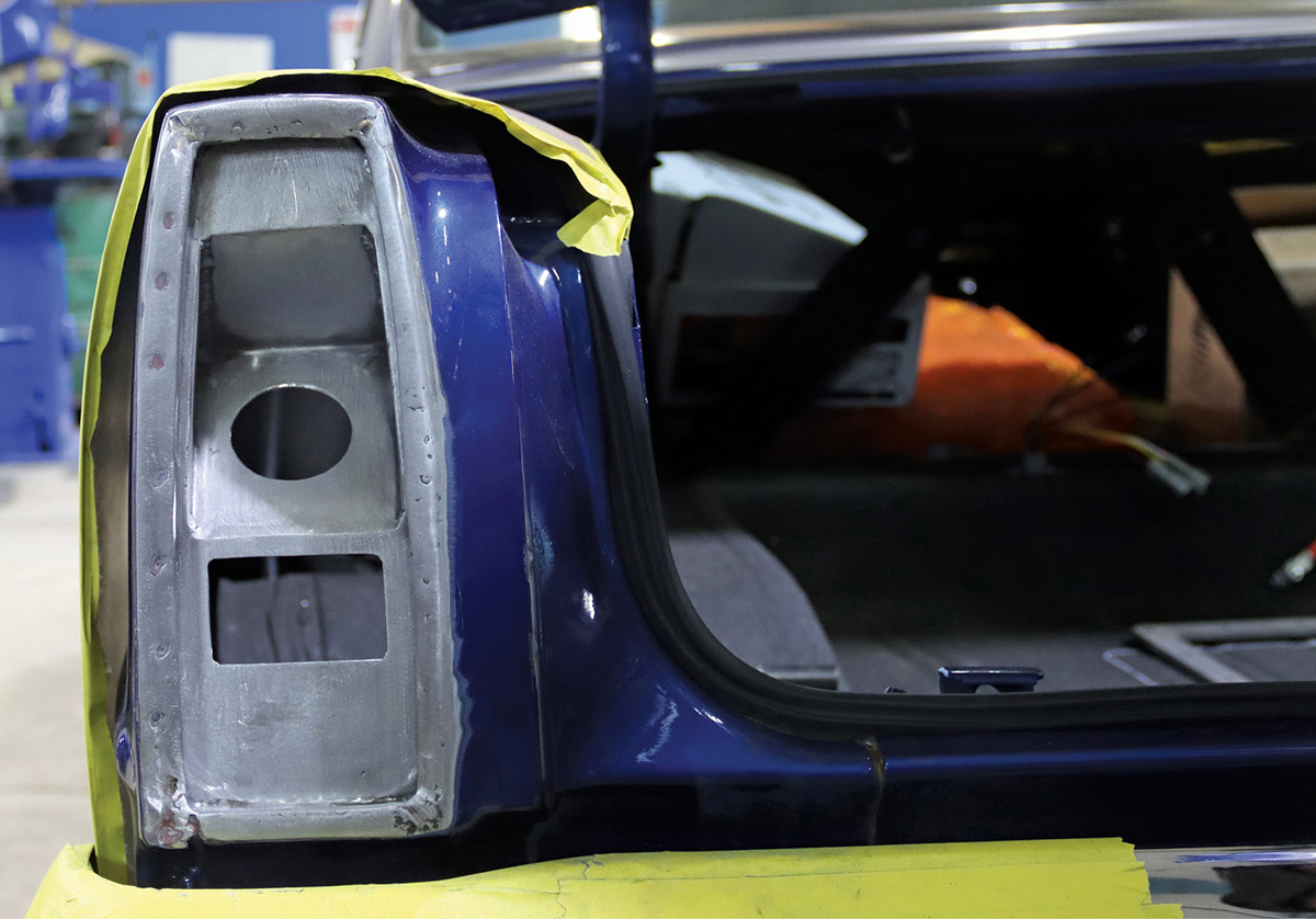 Metal pocket box fitted into the fender opening.