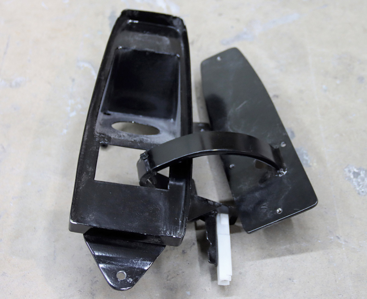 Black painted hidden filler assembly in the open position.