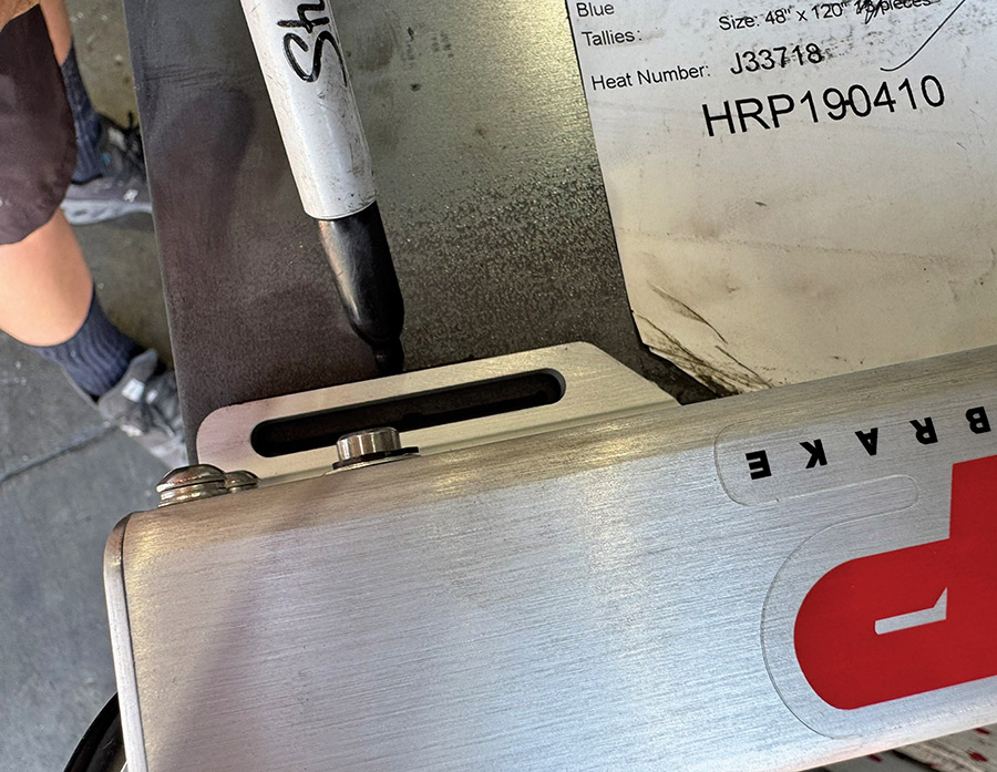 Outlining the mounting bracket on a metal plate.