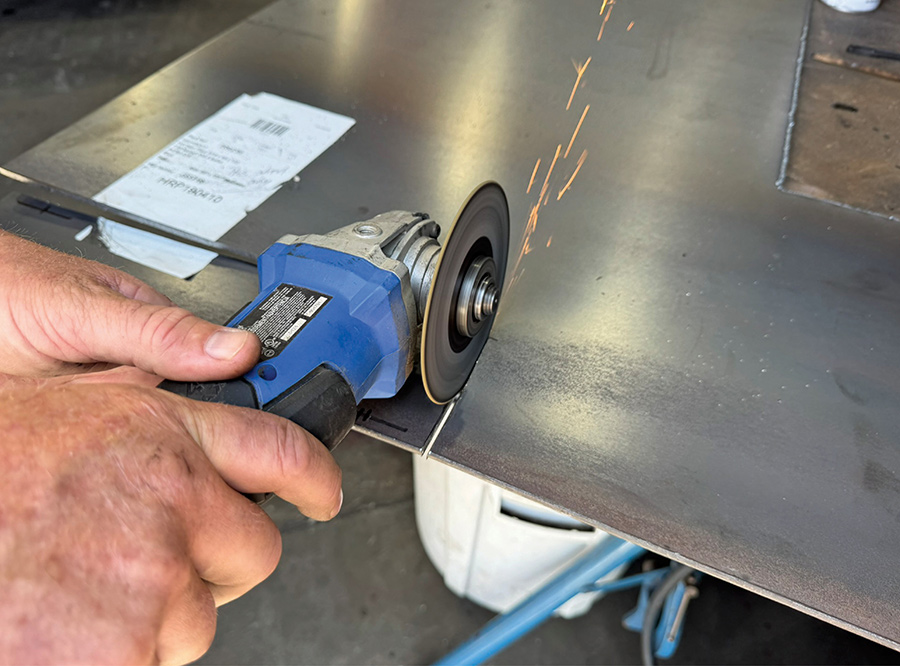 Cutting a metal plate with an angle grinder.