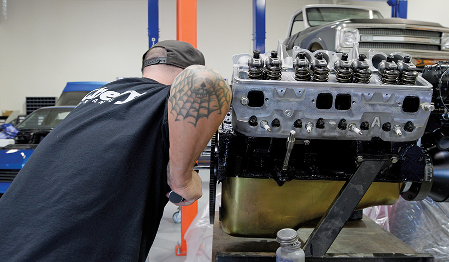 Lowering the 383 engine into the bay.