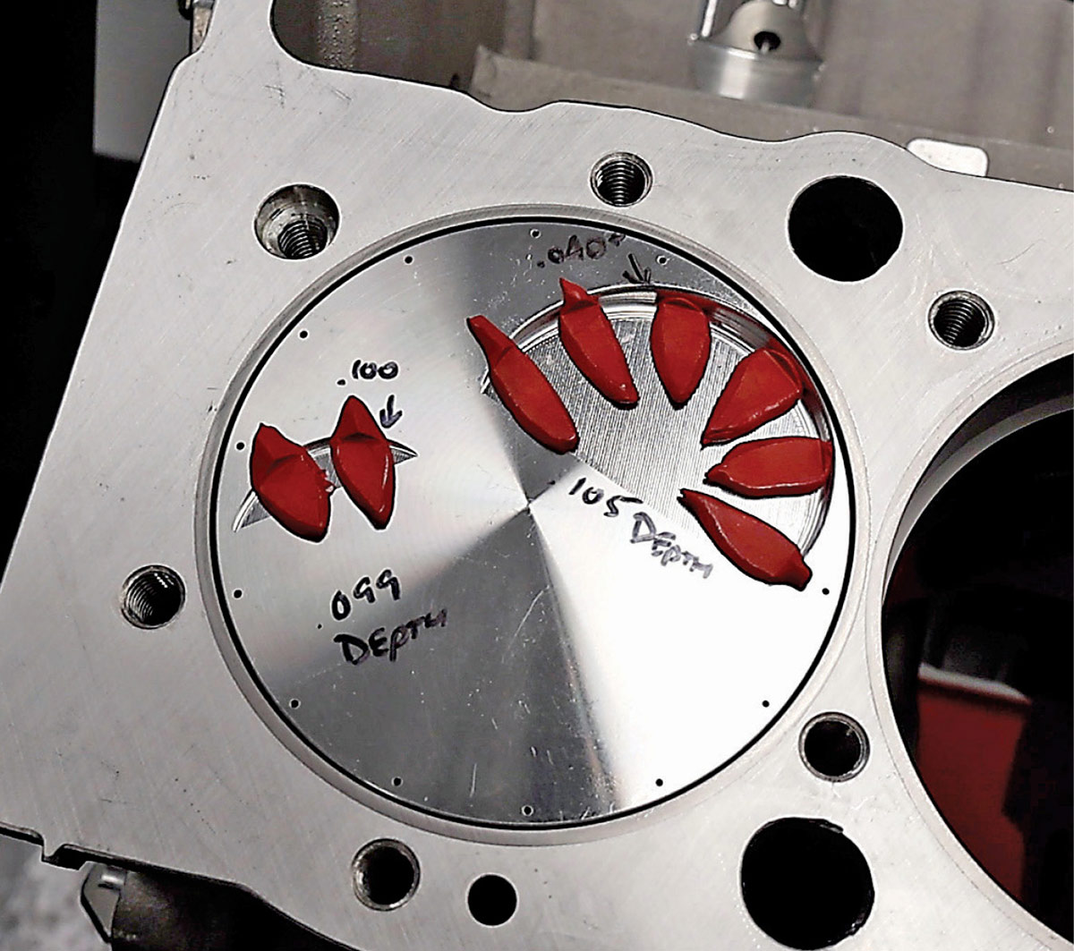 Checking piston-to-valve clearance using clay on a piston top.