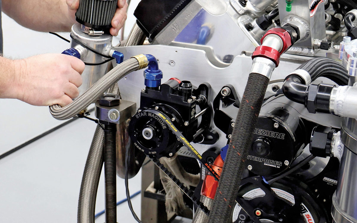 Plumbing a vacuum pump for the dry-sump oiling system.