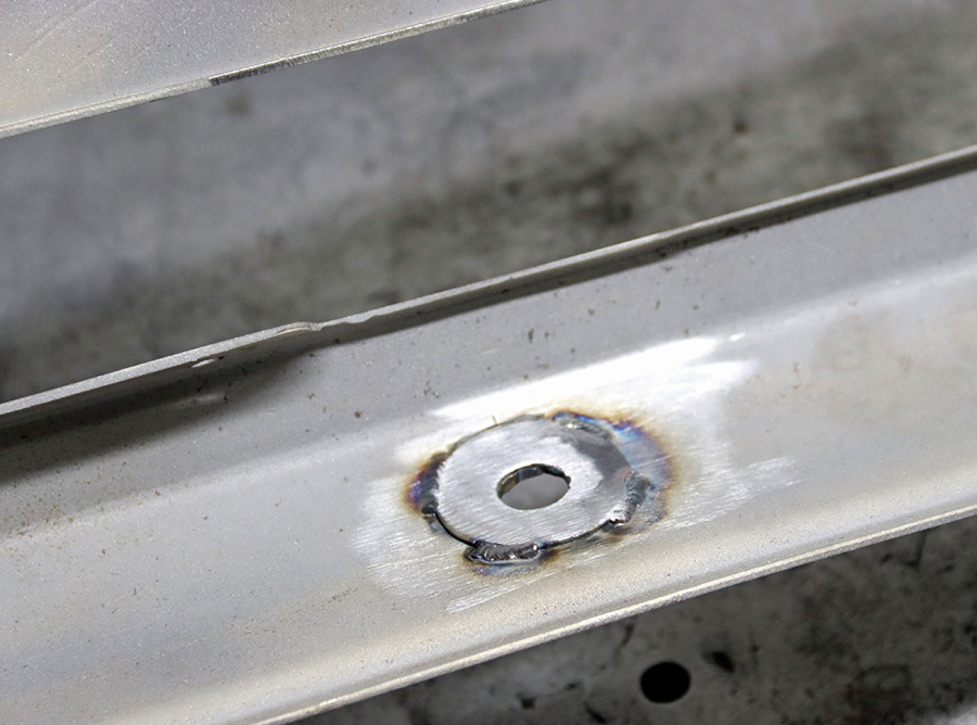 Filling factory bumper bolt holes with washers.