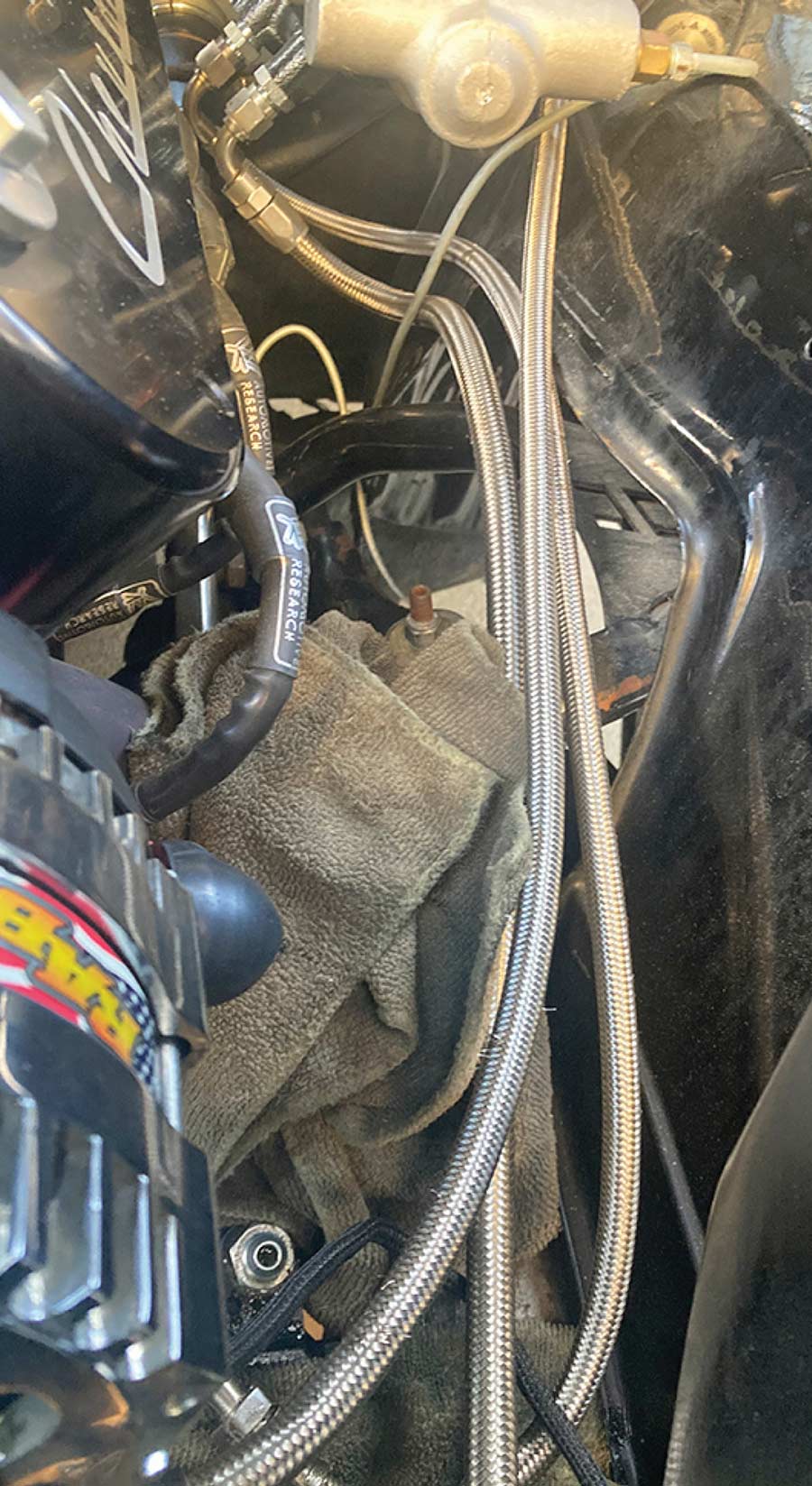 View of messy engine compartment hoses.