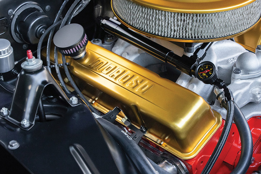 Detail of gold Moroso valve covers and fuel pressure gauge on engine.