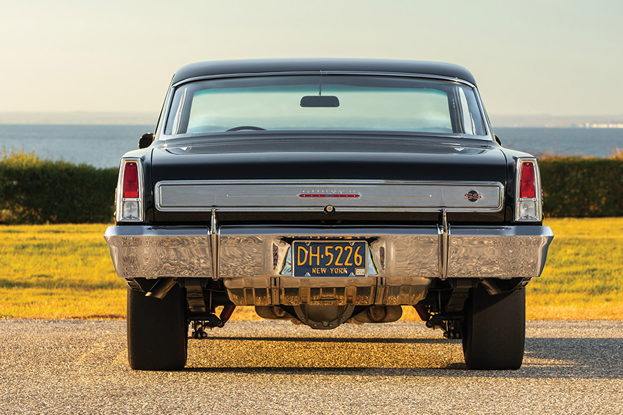 Rear view of a black 1966 Chevy II Nova showing drag tires.