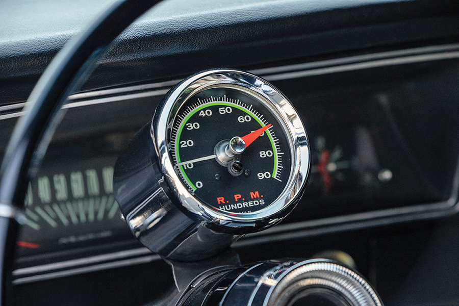 Close-up of a vintage Sun Green Line tachometer on the steering column.