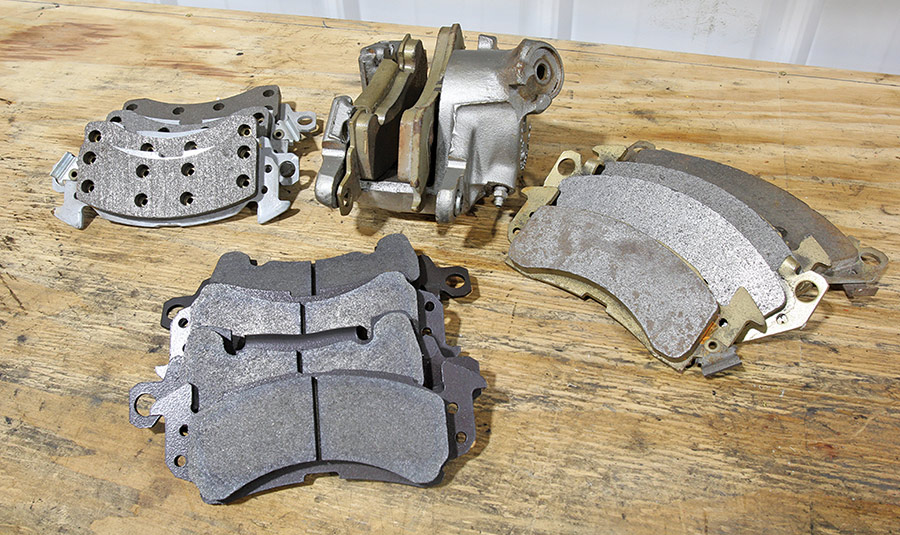 Assortment of front disc brake pads showing various friction material designs.