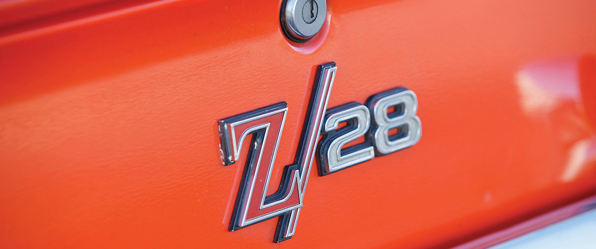 Red and silver Z/28 emblem on orange paint