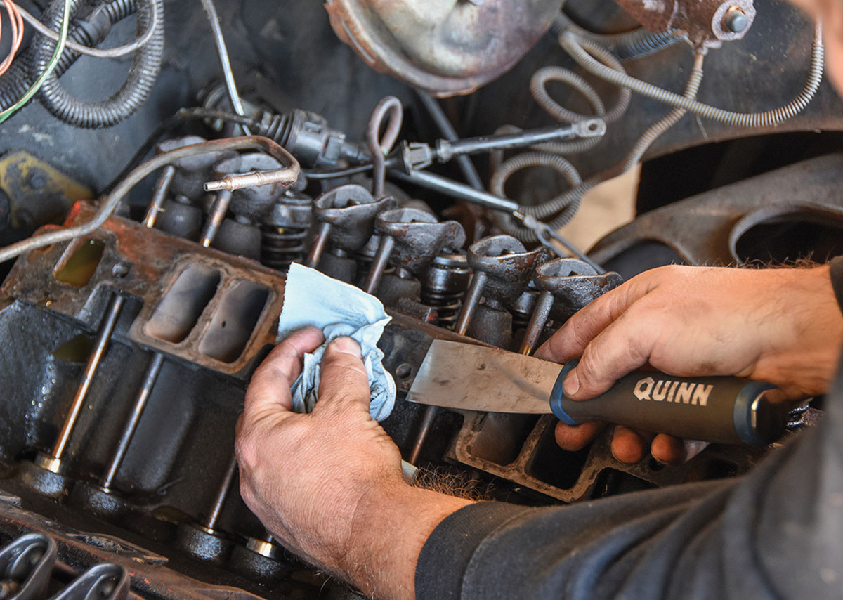 Scraping old gasket material off the cylinder heads.
