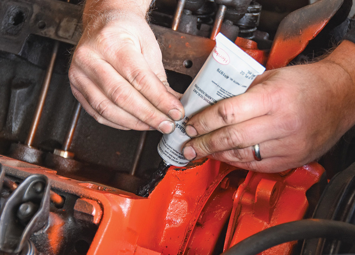 Applying RTV sealant to the engine block.
