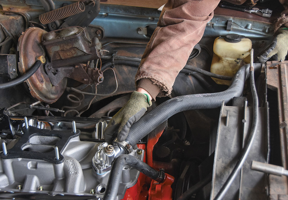 Reinstalling the original thermostat housing and radiator hoses.