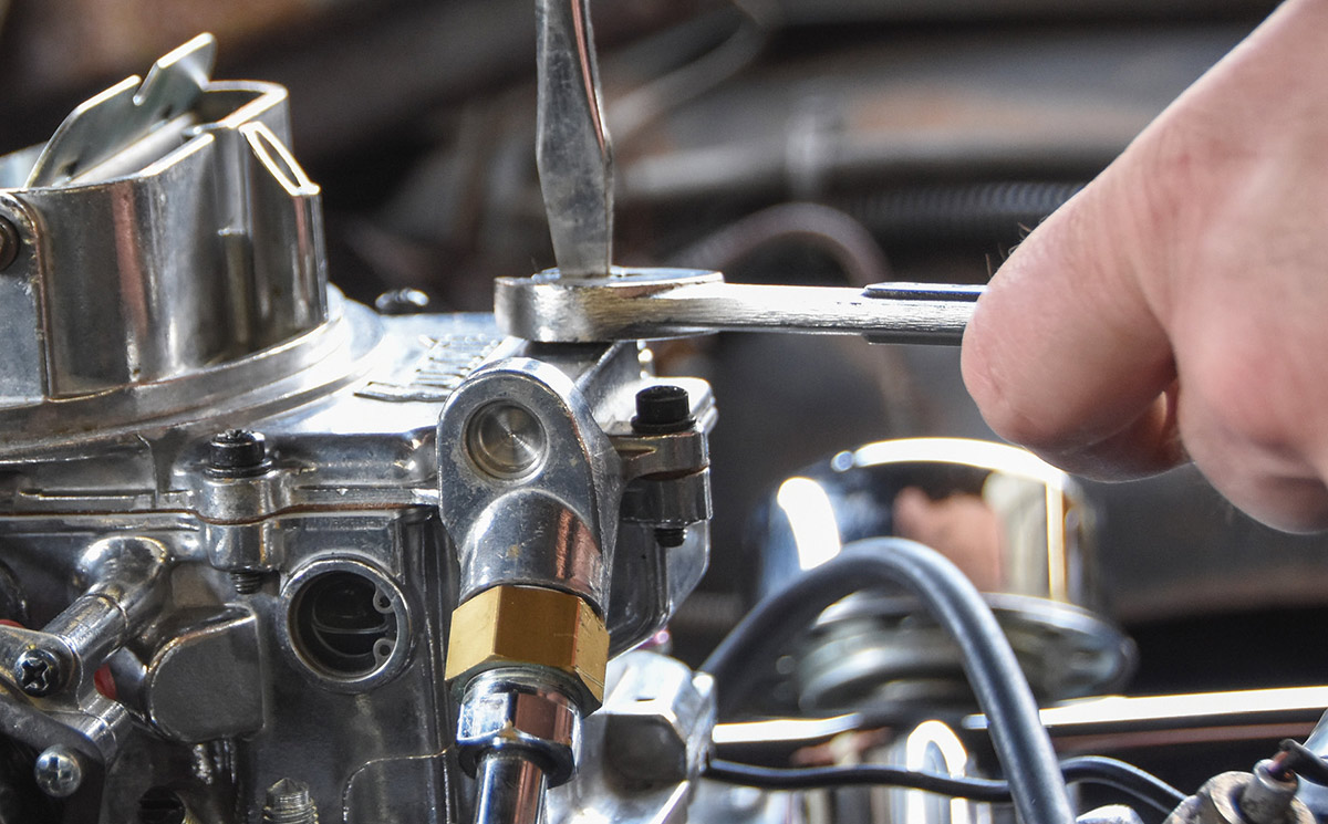Adjusting the idle mixture screws on the carburetor.