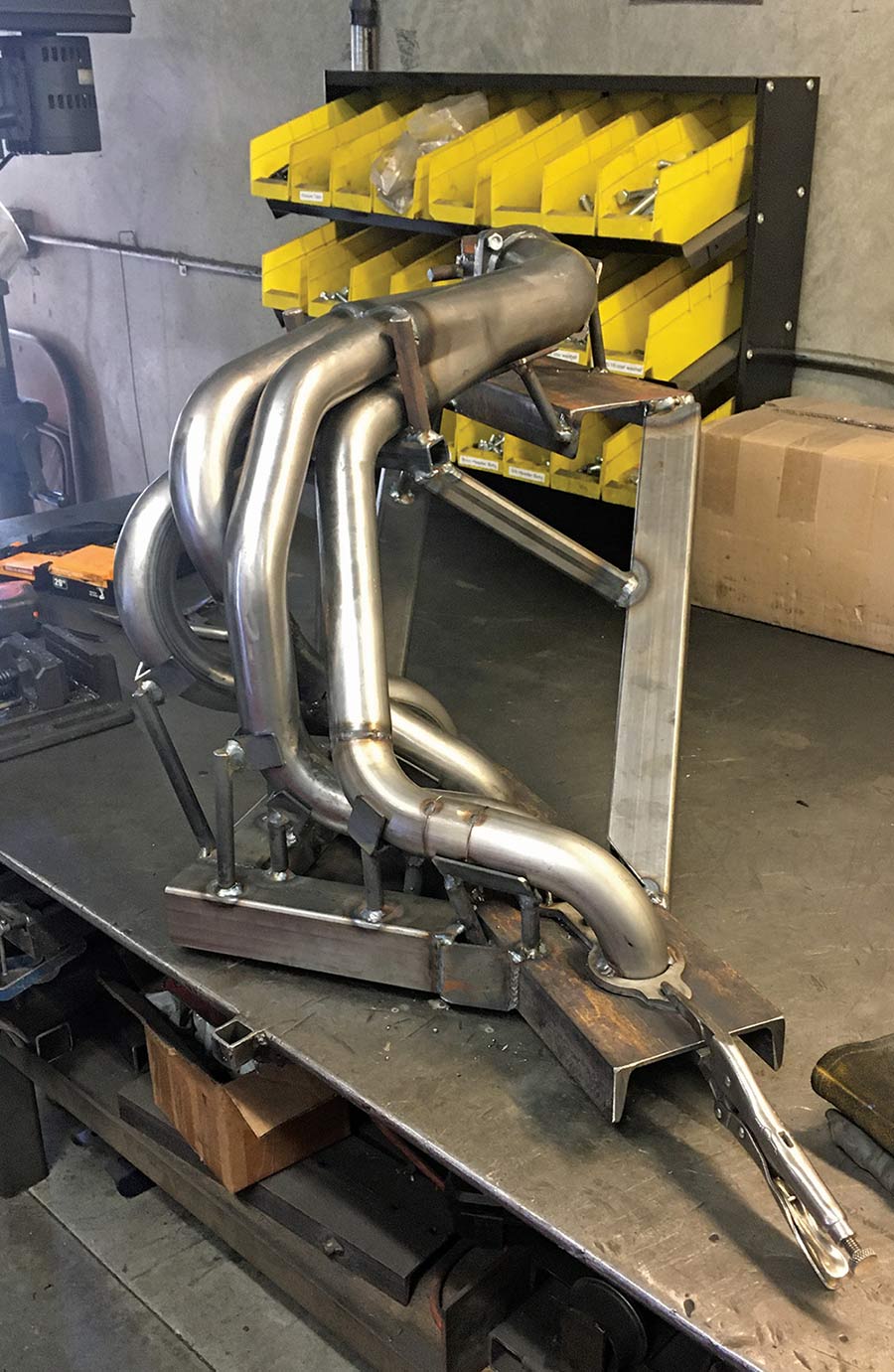 Custom exhaust headers on a metal fabrication bench.