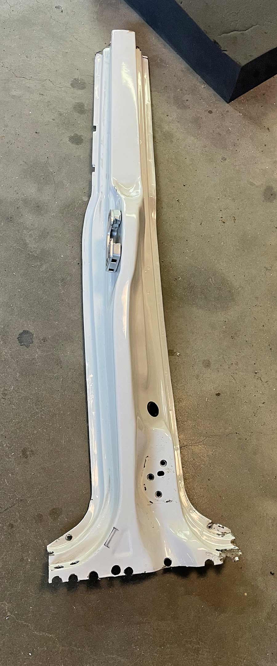 White B-pillar piece removed from the car body.
