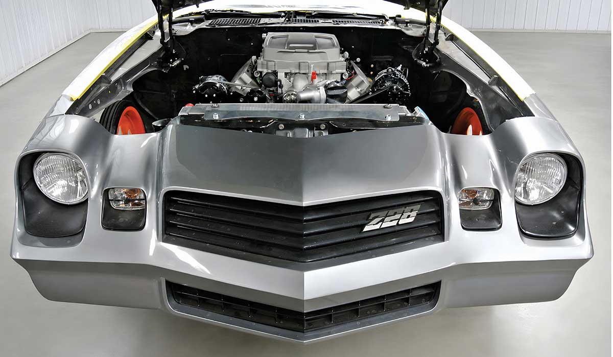 Front view of silver Camaro with custom engine bay.