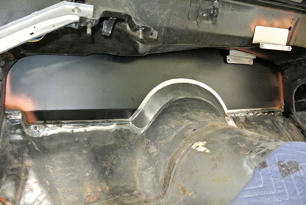 Black filler panel fitted for bellhousing clearance.