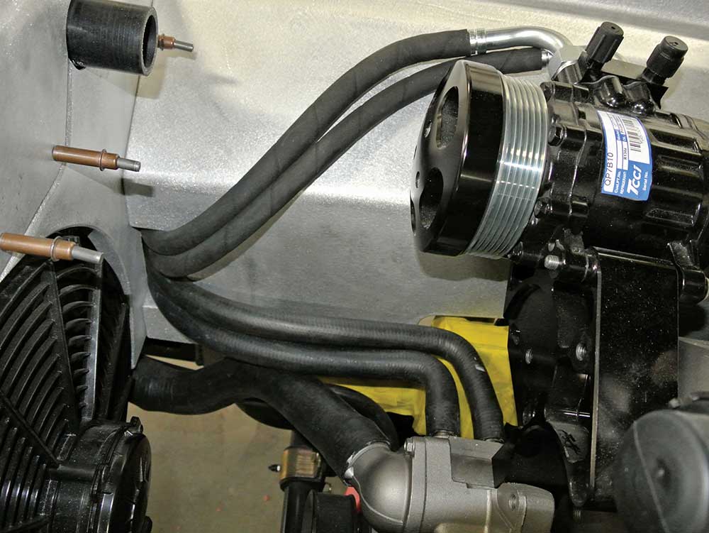 Climate control hoses passing through a flanged opening.