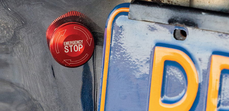 Red emergency stop button mounted near the rear license plate.