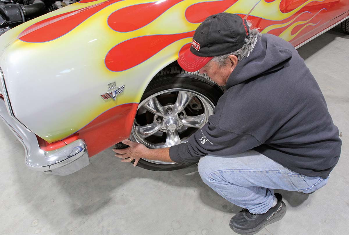Mechanic manually cycling steering wheel to bleed air from the hydraulic system.