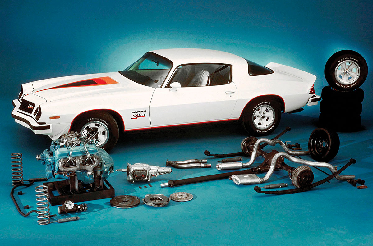 White 1977 Camaro Z28 with disassembled performance parts.