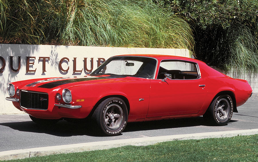 Red second-generation Camaro Z28 with black racing stripes.