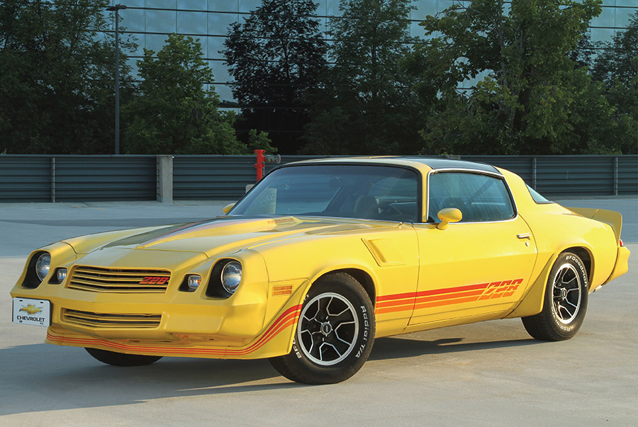 Bright yellow 1980 Camaro Z28 with red side graphics.