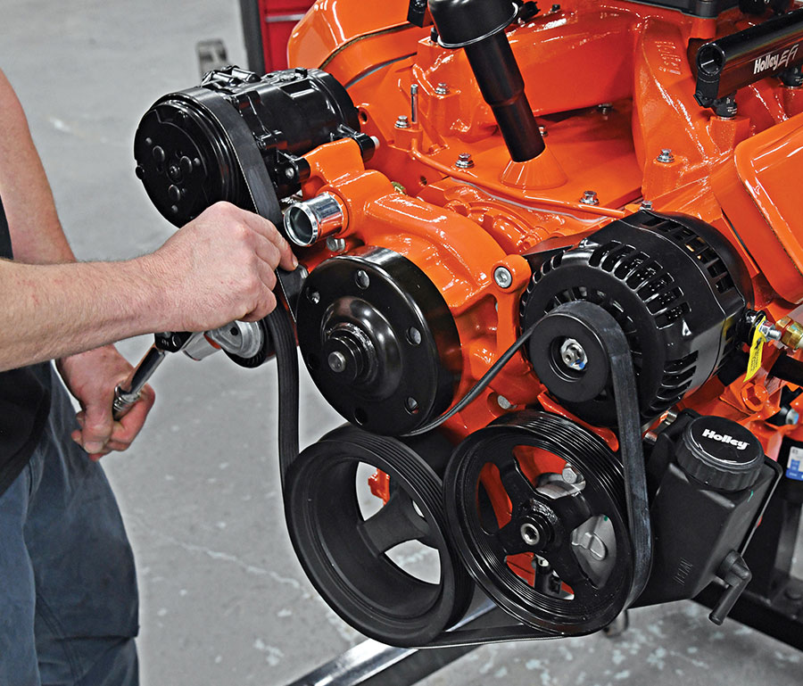 Adjusting the serpentine belt tensioner.