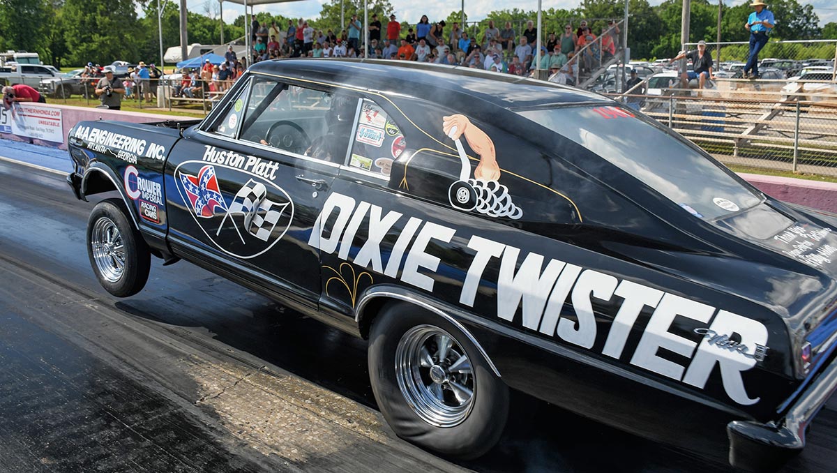 Black "Dixie Twister" Chevy gasser with front wheels up.