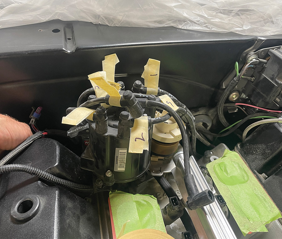 Detail of ignition wires tagged with masking tape and marker.