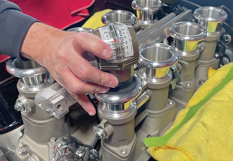 Measuring airflow volume through a throttle body with a synchrometer.