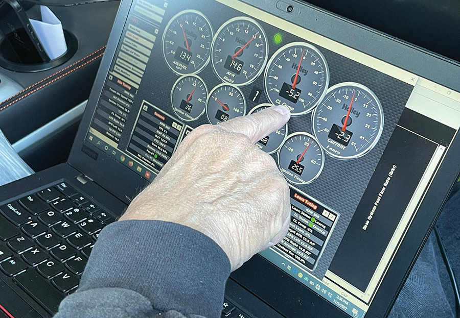 Steve Sbelgio correcting air/fuel ratio using digital gauges on a laptop.