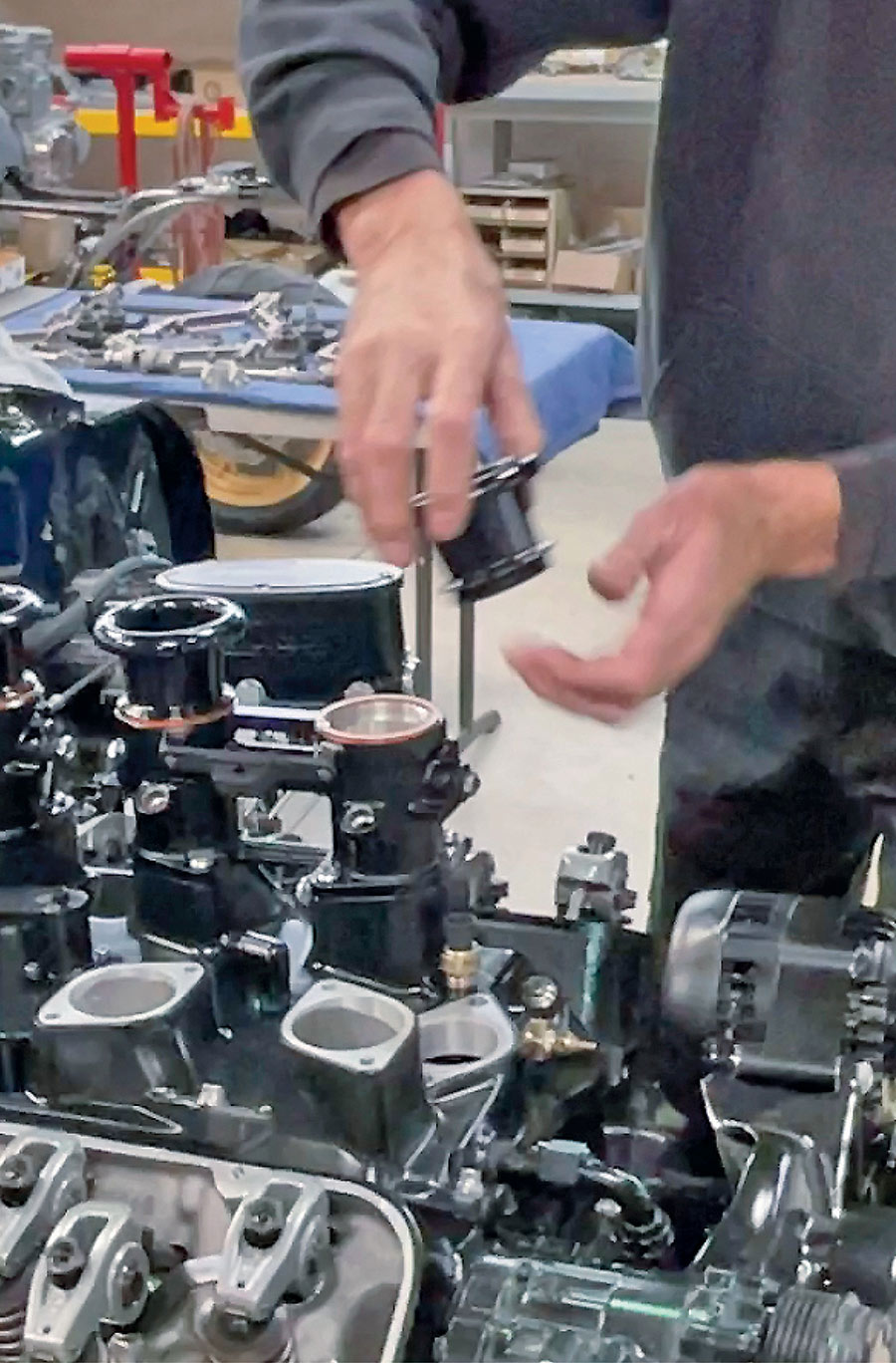 Careful assembly of the painted and anodized intake components.