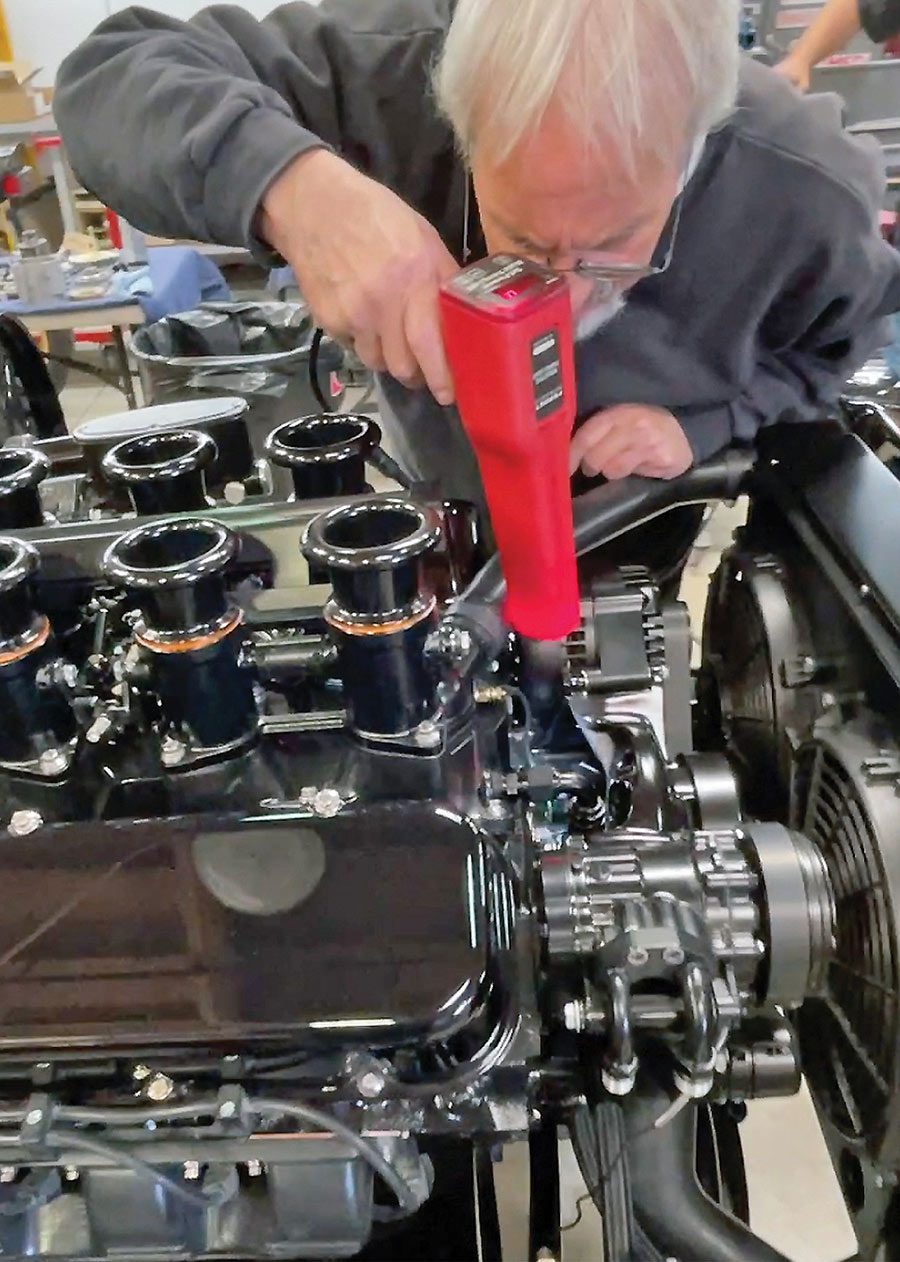 Checking engine ignition timing with a light during tuning.