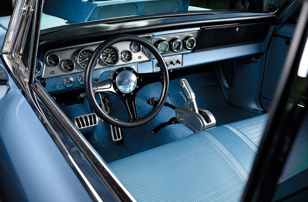 Interior of the Nova with light blue upholstery and custom gauges.